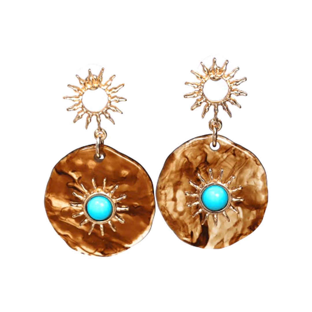 Gold earrings with turquoise stones on a white background