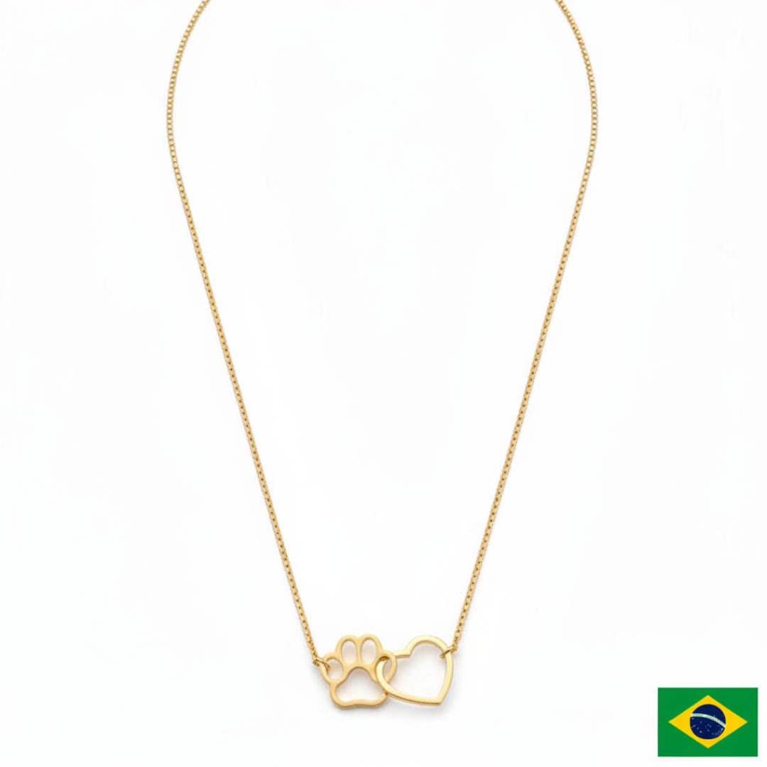 Gold necklace with paw print and heart pendant on a white background
