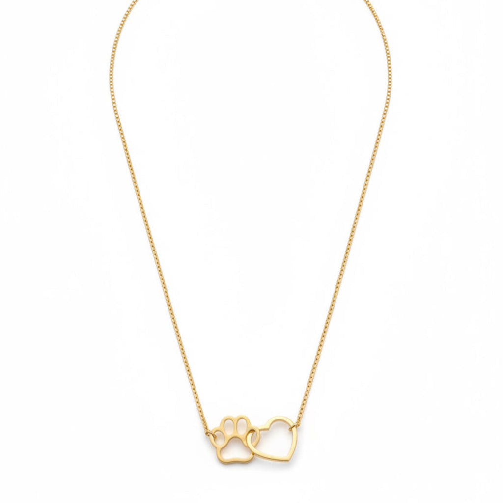 Gold necklace with a paw print and heart pendant on a white background